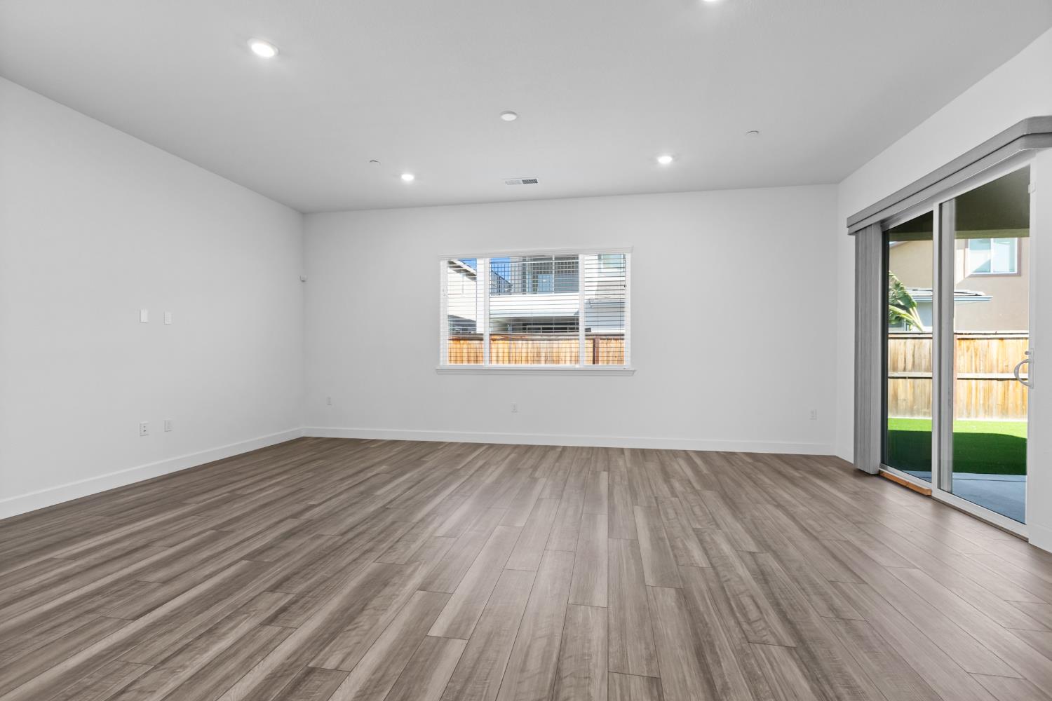 4236 Bellwether Way Sacramento, CA 95835 - Photo 7 of 57 an empty room with wooden floor and windows