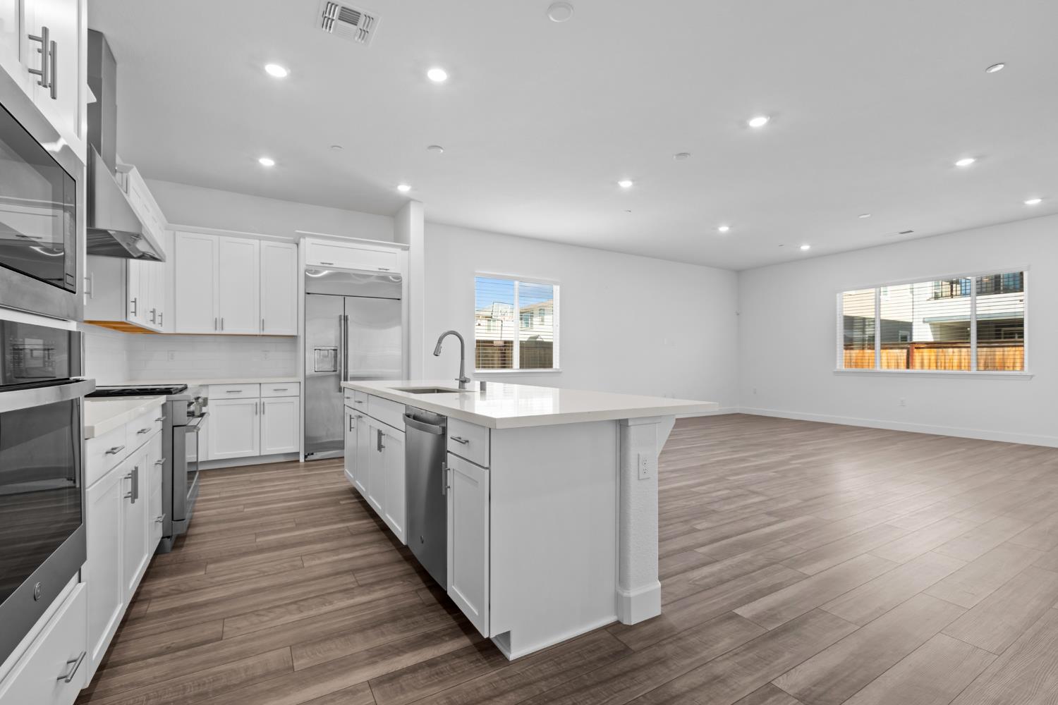 4236 Bellwether Way Sacramento, CA 95835 - Photo 10 of 57 a large kitchen with stainless steel appliances granite countertop a stove and a sink