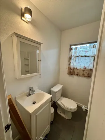 a white toilet sitting next to a bathroom sink