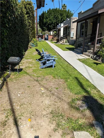 a view of a house with backyard porch and sitting area