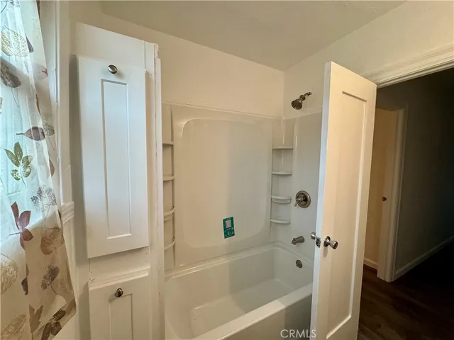 a bathroom with a bathtub and a shower