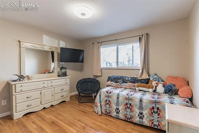 a bedroom with a bed and flat screen tv