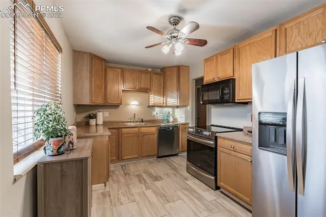 a kitchen with a sink stainless steel appliances and cabinets
