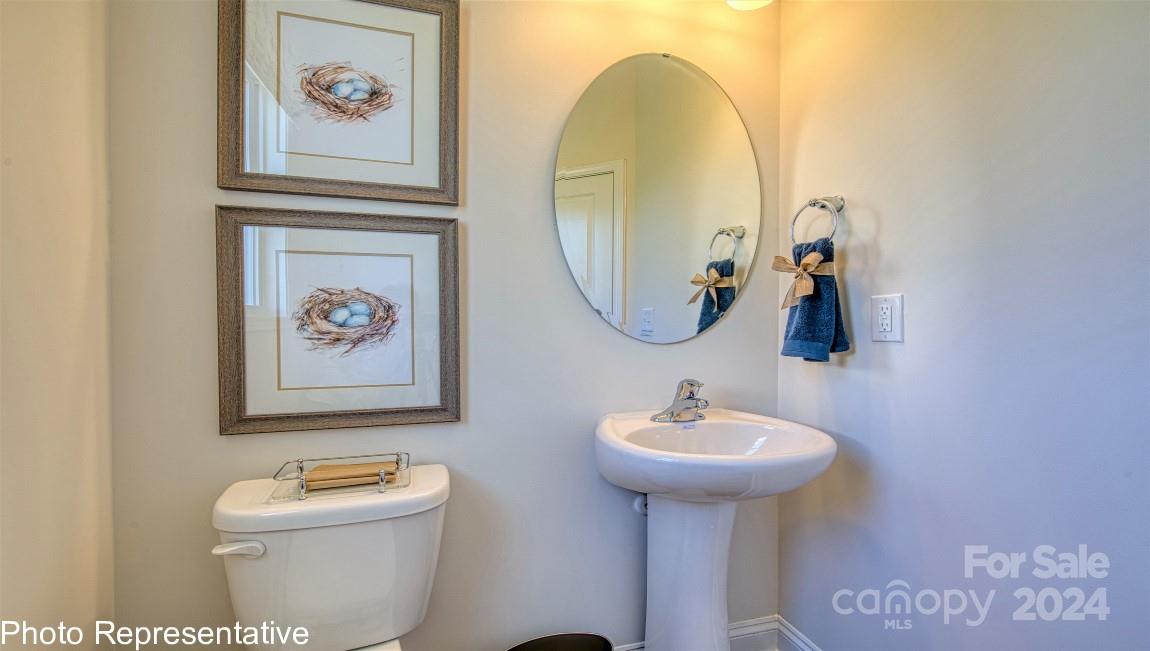 542 Wheatfield Road Fletcher, NC 28732 - Photo 26 of 47 a bathroom with a toilet sink and mirror