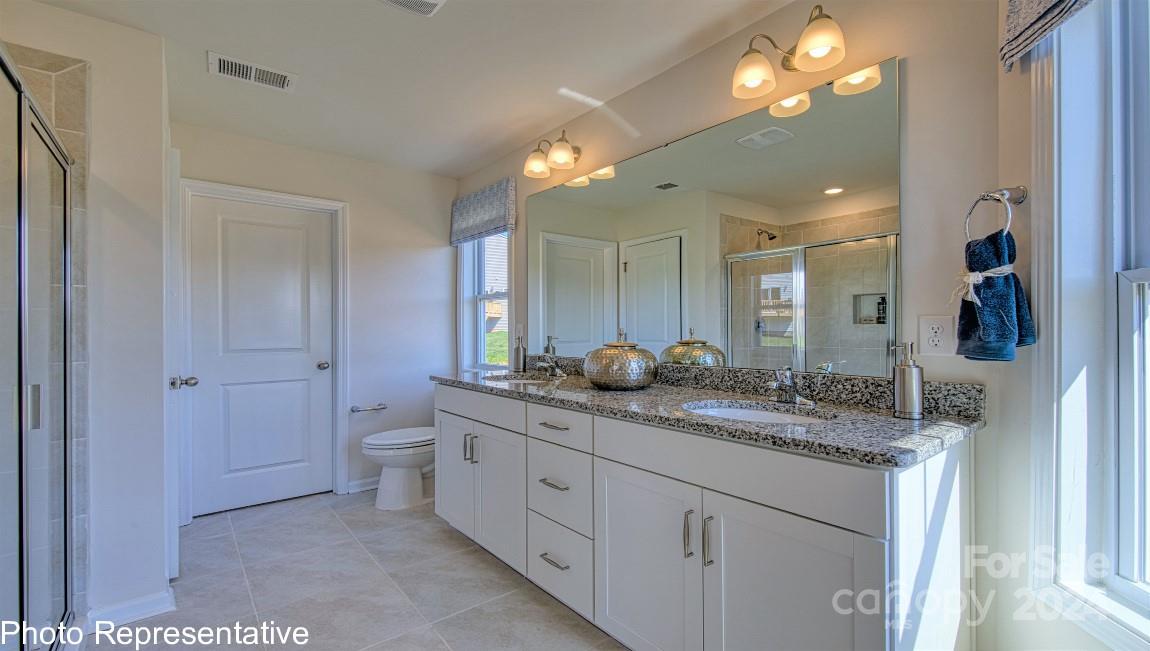 542 Wheatfield Road Fletcher, NC 28732 - Photo 36 of 47 a bathroom with a granite countertop sink mirror and toilet
