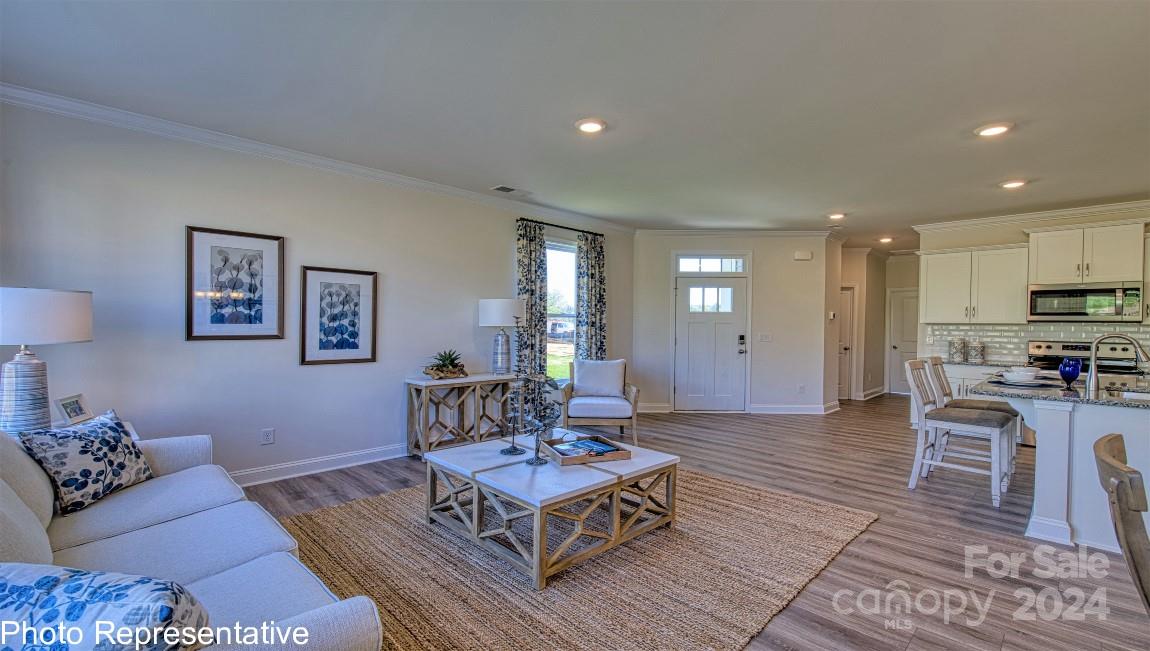 542 Wheatfield Road Fletcher, NC 28732 - Photo 7 of 47 a living room with furniture a rug and kitchen view