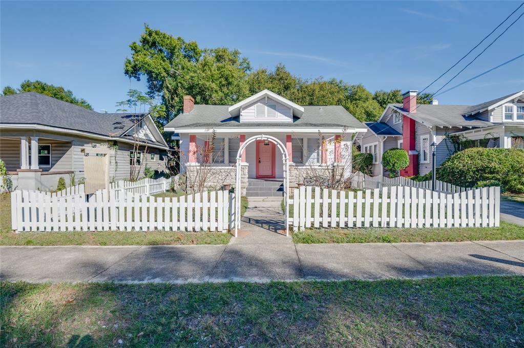 427 East Washington Avenue Eustis, FL 32726 - Photo 1 of 42 a front view of a house with a garden