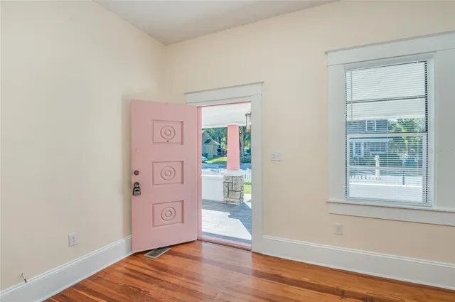 a view of a hallway view with wooden floor and staircase