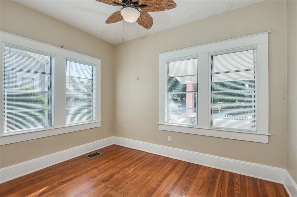427 East Washington Avenue Eustis, FL 32726 - Photo 15 of 42 a view of an empty room with wooden floor and a window