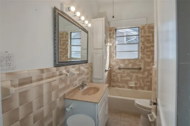 an empty room with a window and wooden floor