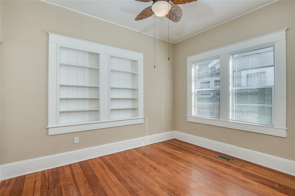 427 East Washington Avenue Eustis, FL 32726 - Photo 18 of 42 an empty room with a window and wooden floor