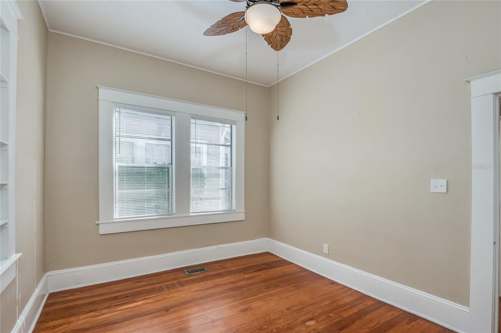 427 East Washington Avenue Eustis, FL 32726 - Photo 19 of 42 a view of an empty room with wooden floor and a window