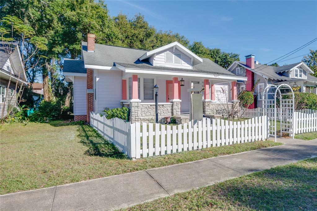 427 East Washington Avenue Eustis, FL 32726 - Photo 2 of 42 a front view of a house with a garden