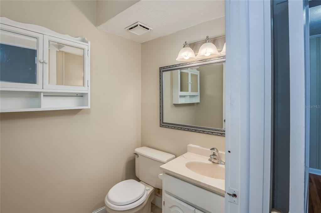 427 East Washington Avenue Eustis, FL 32726 - Photo 23 of 42 a bathroom with a sink vanity mirror and toilet