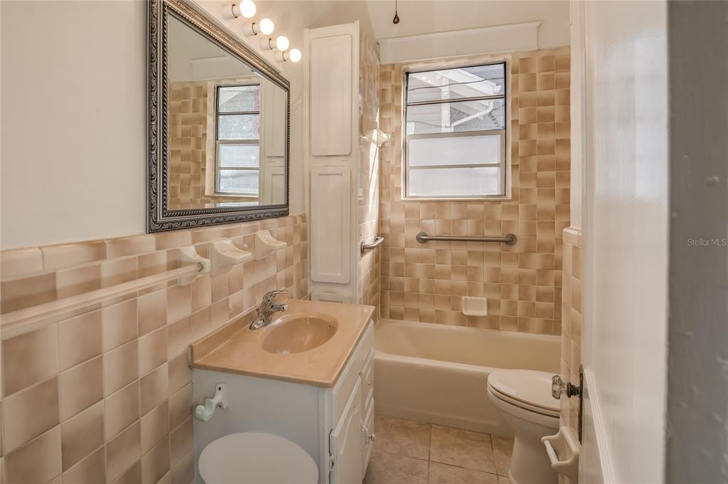 427 East Washington Avenue Eustis, FL 32726 - Photo 28 of 42 a bathroom with a granite countertop toilet sink and shower