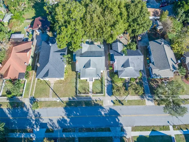 an aerial view of residential houses with outdoor space