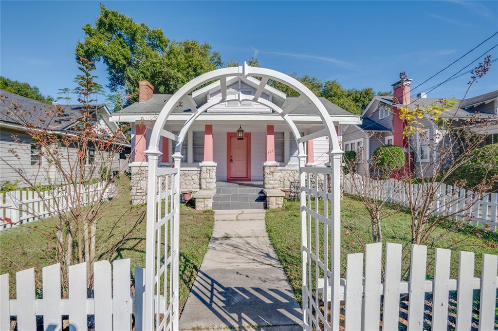 427 East Washington Avenue Eustis, FL 32726 - Photo 4 of 42 a view of a wooden house with a wooden fence