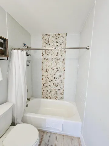 a bathroom with a bathtub and a shower