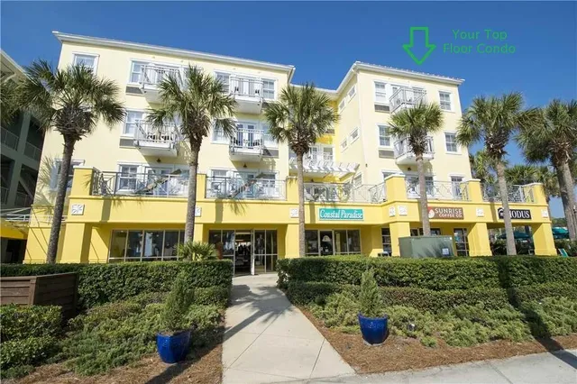 a front view of a building with a garden