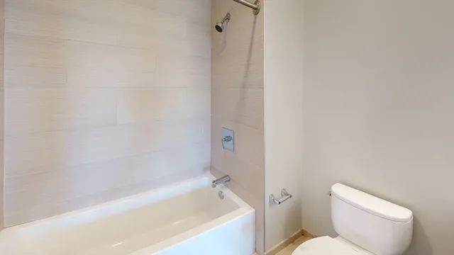 a bathroom with a toilet and bathtub