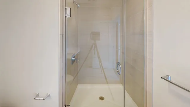 a bathroom with a glass shower door