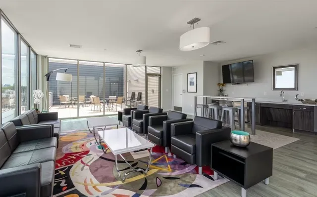 a living room with lots of furniture and kitchen view