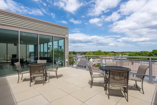 a view of a chairs and table in patio
