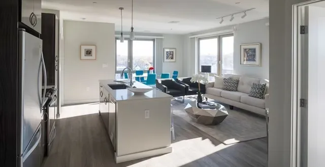 a living room with furniture wooden floor and a chandelier