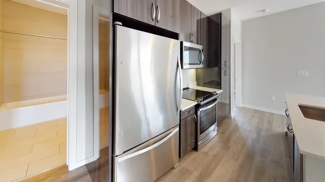 a kitchen with stainless steel appliances a refrigerator and a stove