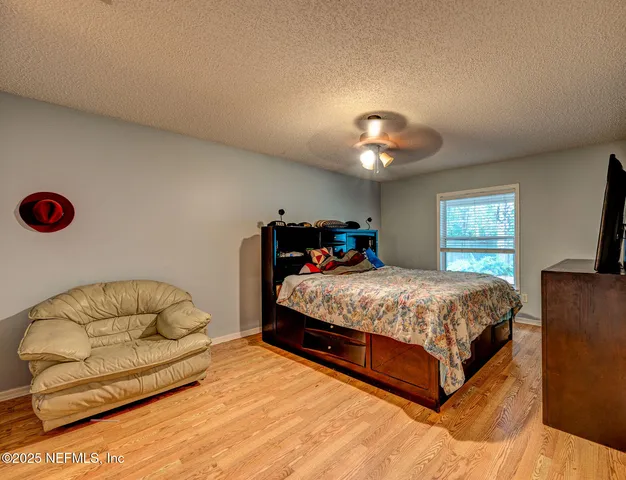 a bedroom with a bed and a couch