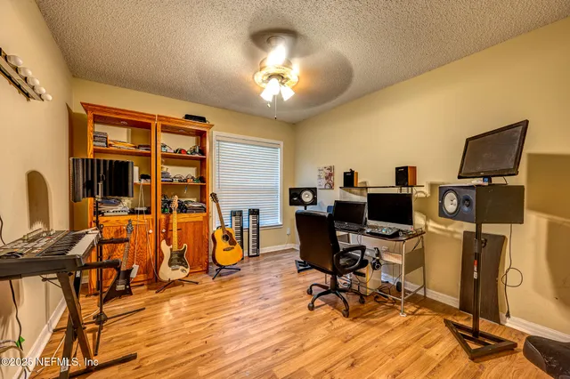 a view of a livingroom with workspace and a window
