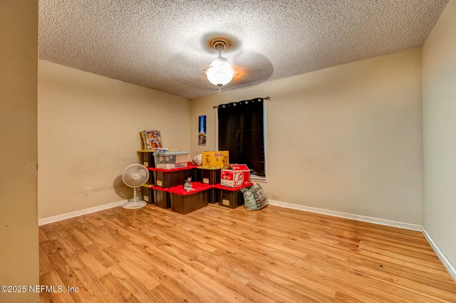 a bedroom with furniture and wooden floor