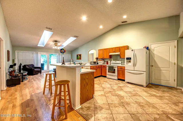 a kitchen with stainless steel appliances lots of counter top space cabinets and furniture