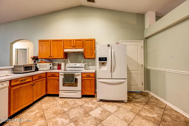 a kitchen with stainless steel appliances a refrigerator sink and cabinets