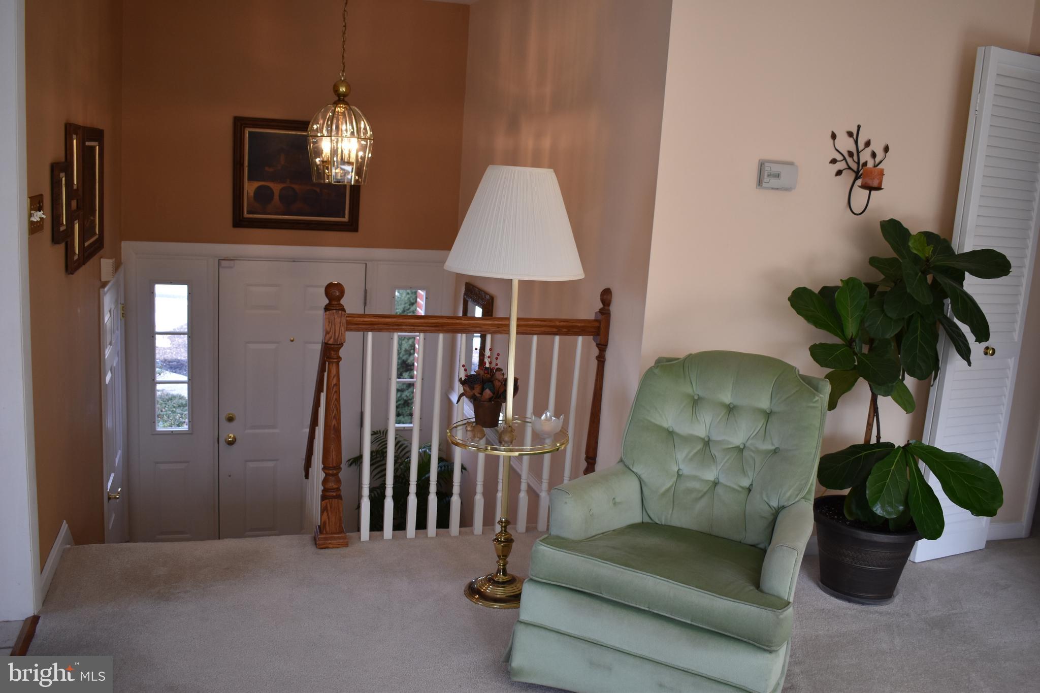 4420 Wynn Road Baltimore, MD 21236 - Photo 13 of 43 a living room with furniture a chandelier and a potted plant