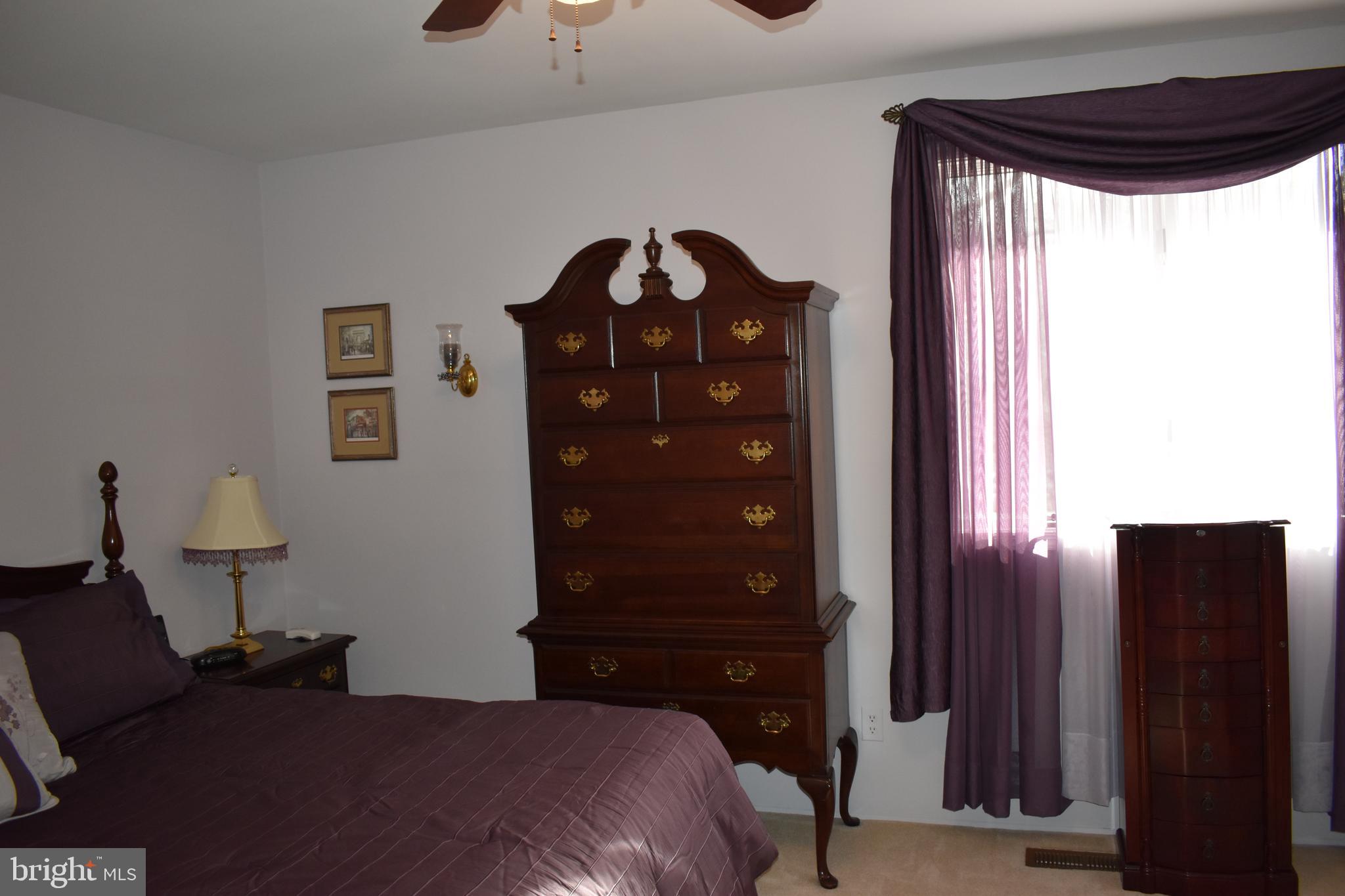4420 Wynn Road Baltimore, MD 21236 - Photo 17 of 43 a bedroom with a bed and a dresser