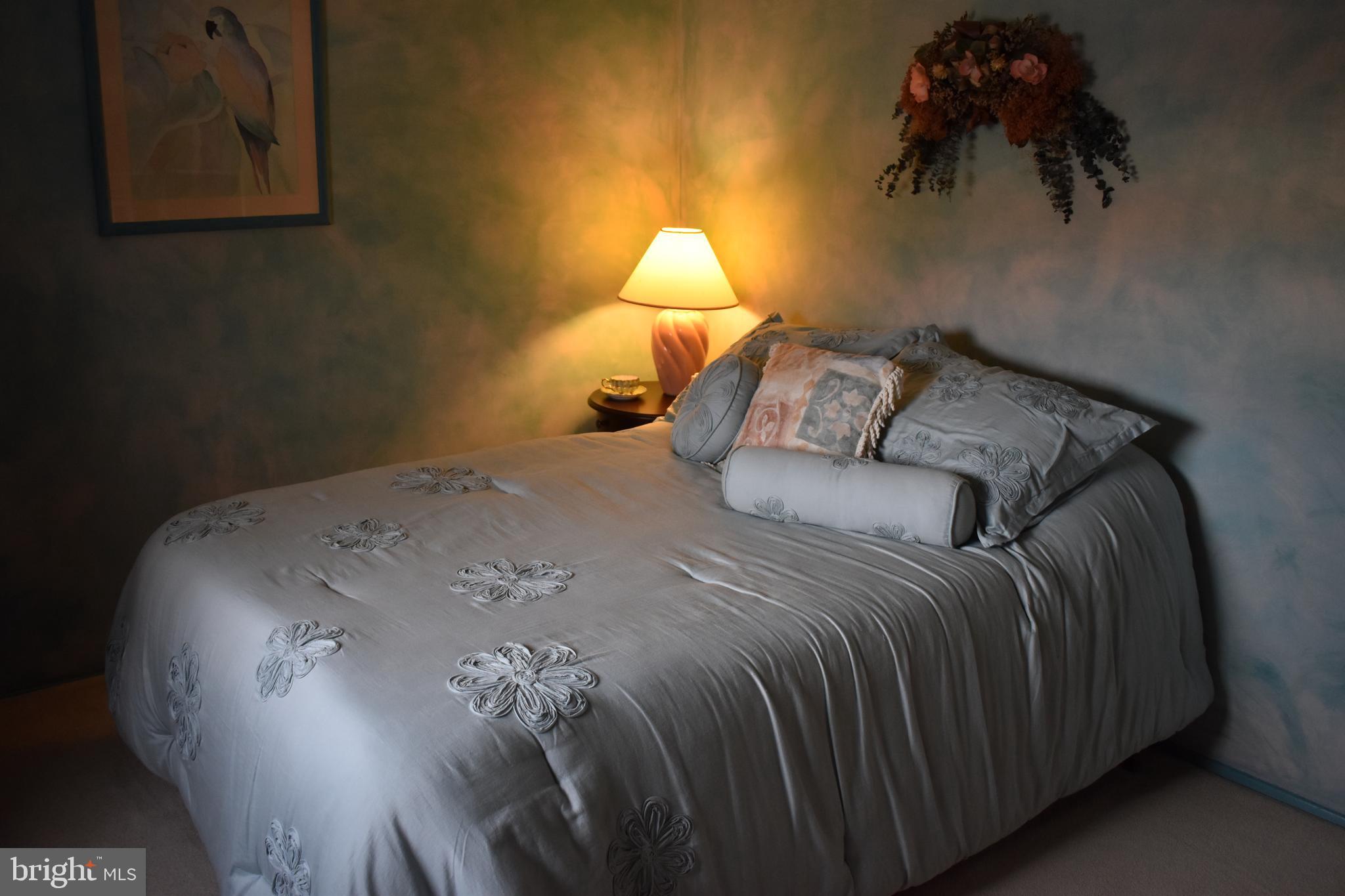 4420 Wynn Road Baltimore, MD 21236 - Photo 21 of 43 a bed sitting in a bedroom next to a lamp
