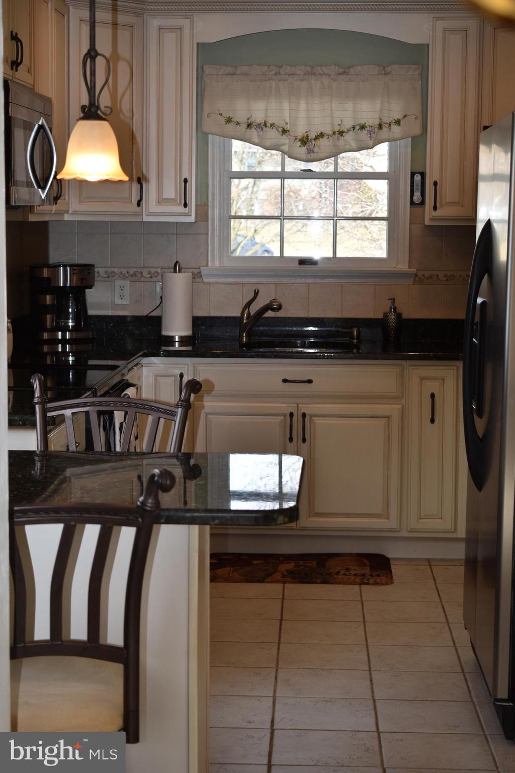 4420 Wynn Road Baltimore, MD 21236 - Photo 4 of 43 a kitchen with stainless steel appliances granite countertop a sink stove and cabinets