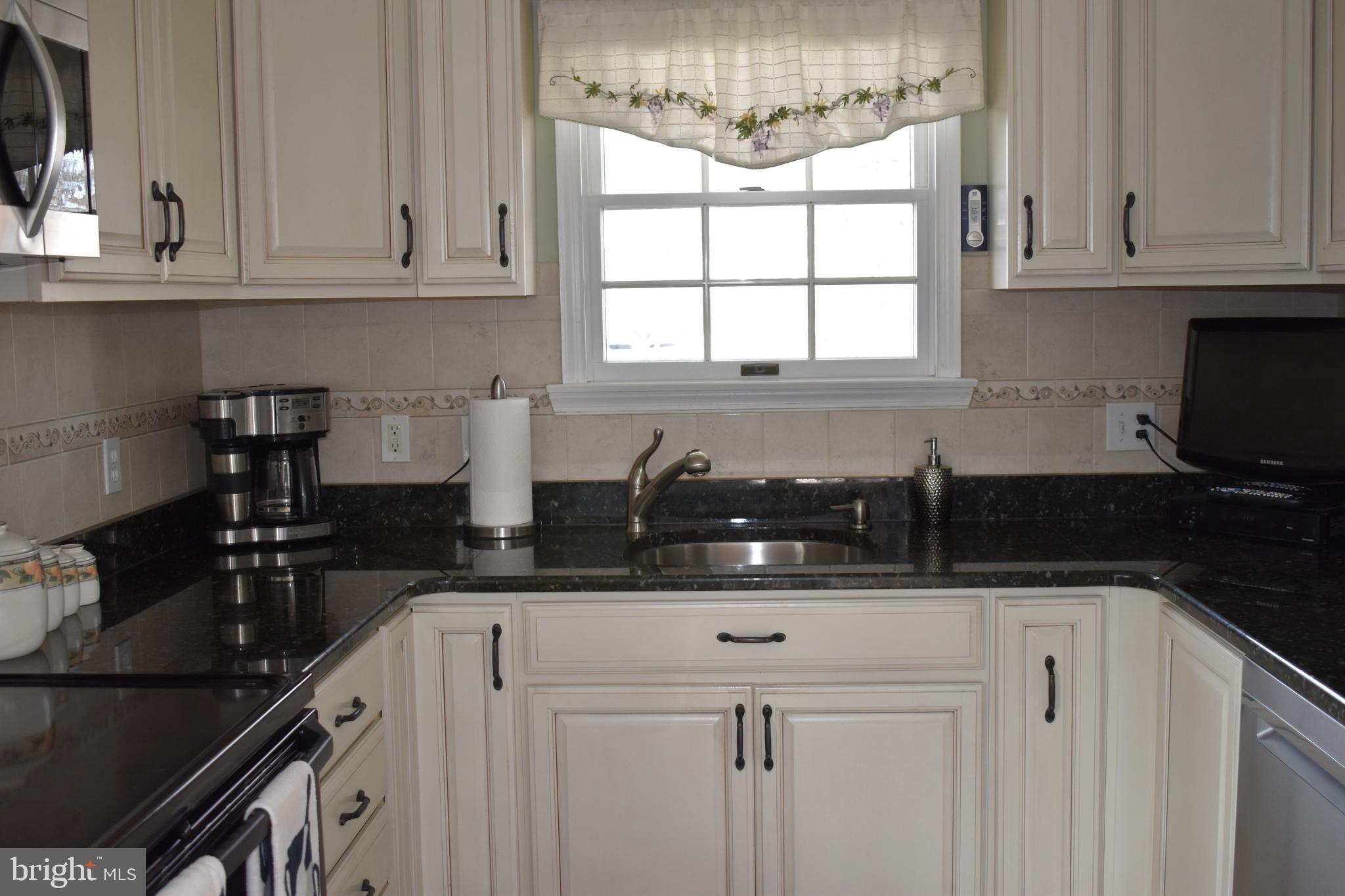 4420 Wynn Road Baltimore, MD 21236 - Photo 6 of 43 a kitchen with a sink cabinets and window