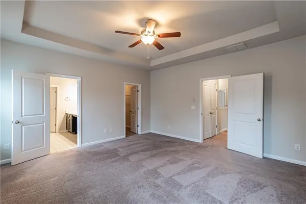 a view of a livingroom with a ceiling fan a ceiling fan and a window