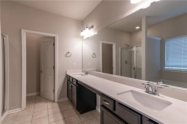 a bathroom with a granite countertop sink a mirror and a vanity