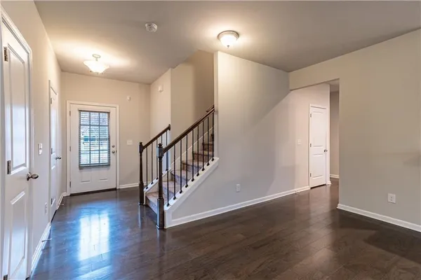 a view of an entryway with wooden floor