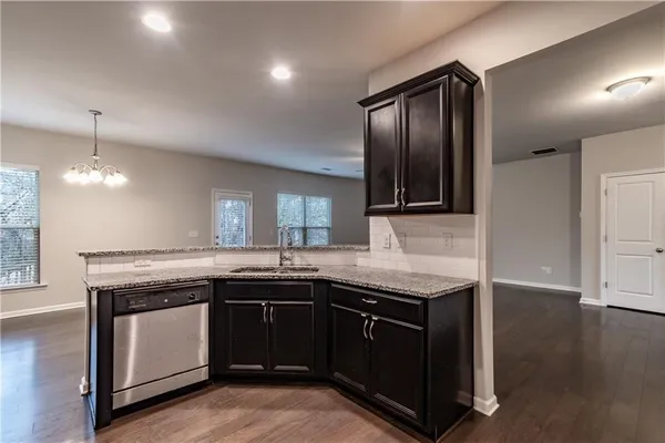 a kitchen with granite countertop a sink and cabinets