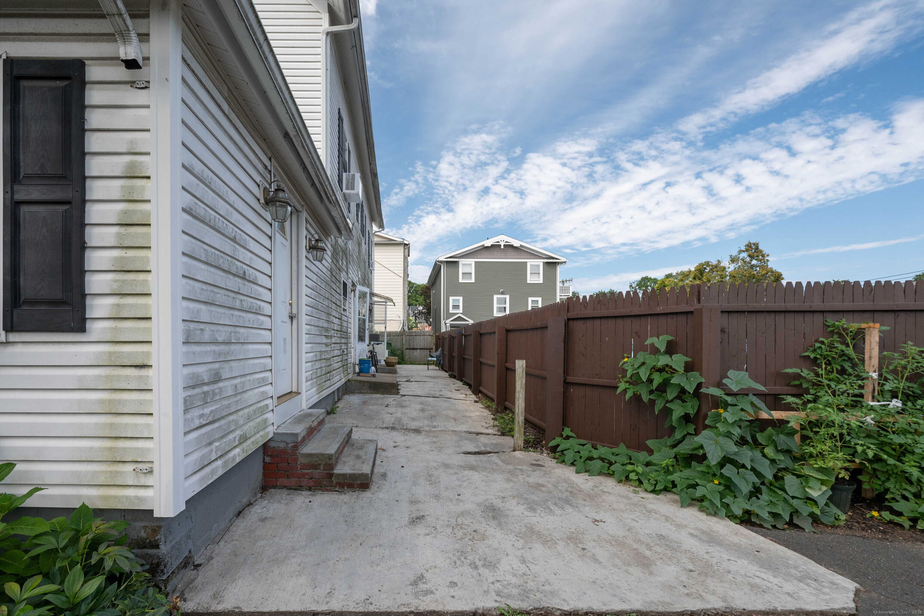 5 Patch Street Danbury, CT 06810 - Photo 7 of 21 a view of a pathway of a house with a yard and potted plants
