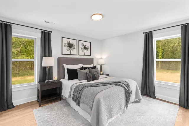 a bedroom with a bed and a large window