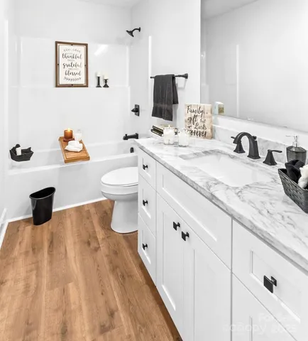 a bathroom with a sink double vanity and a toilet