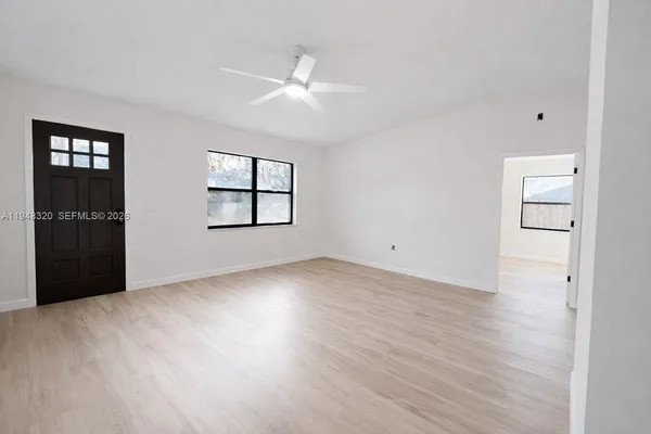 an empty room with windows and closet
