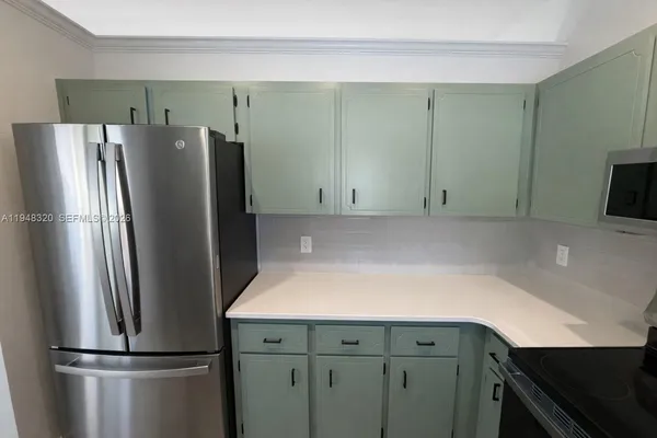 a kitchen with stainless steel appliances a refrigerator and a sink