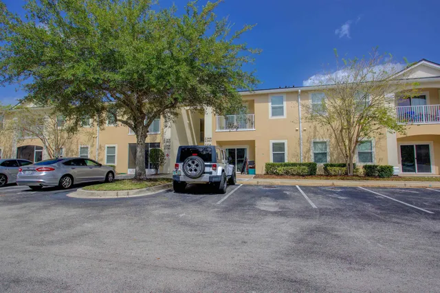a view of a cars park in front of a building