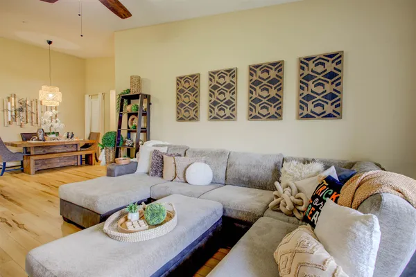 a living room with furniture and wooden floor